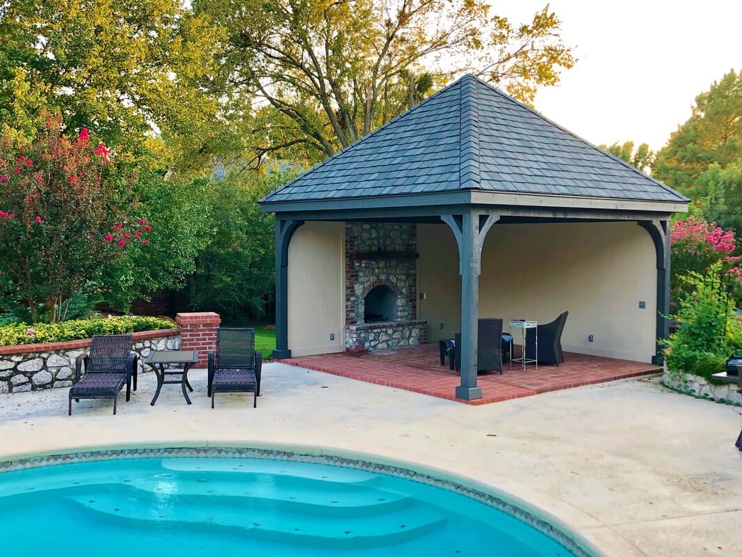 A pool with a gazebo and chairs around it