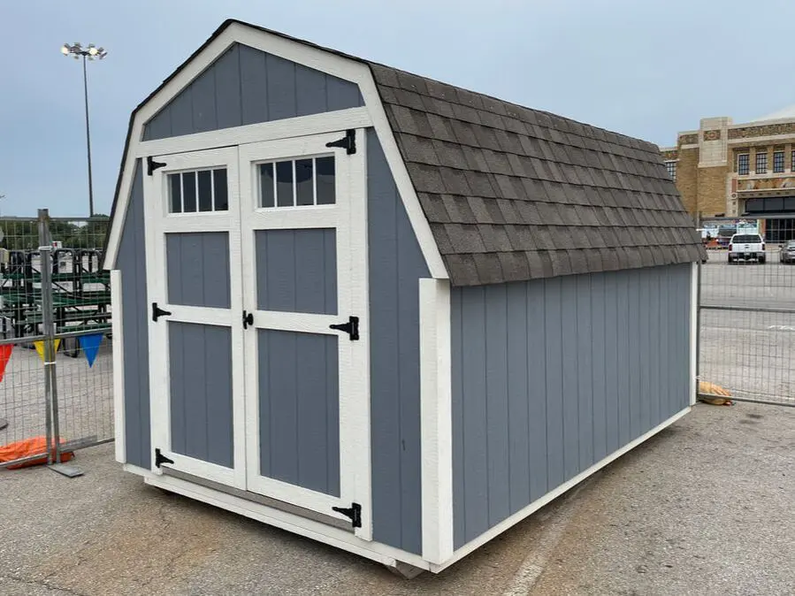 A blue and white shed with two windows.