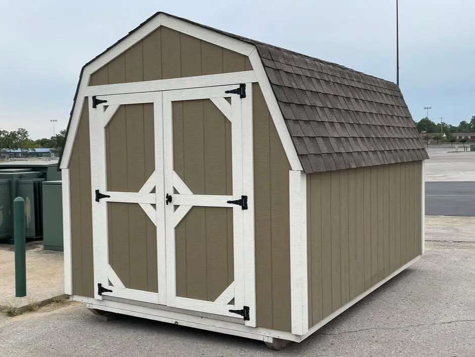 A brown and white shed with two doors.