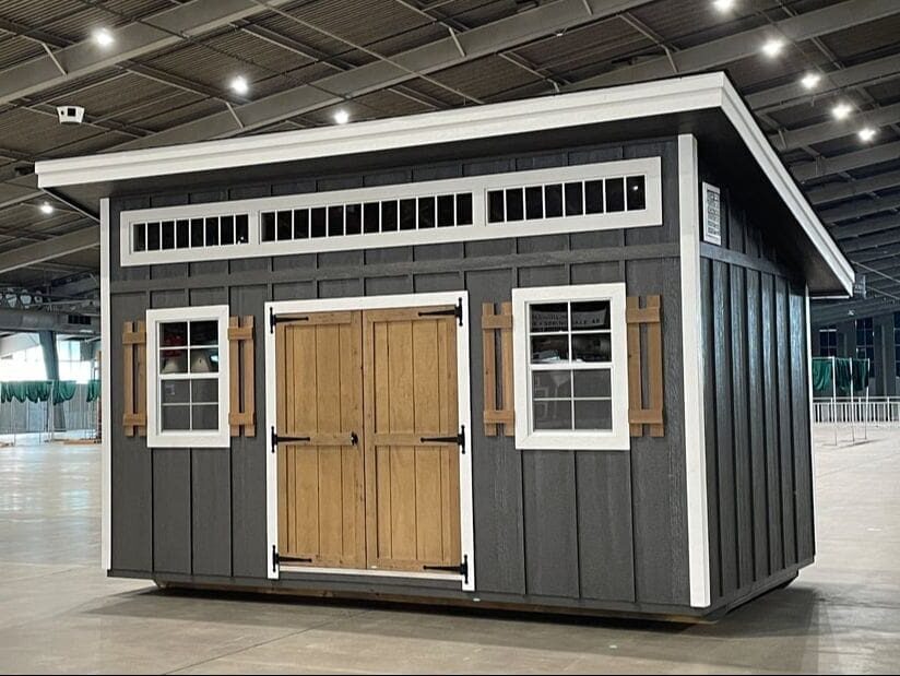A shed with two windows and a door.