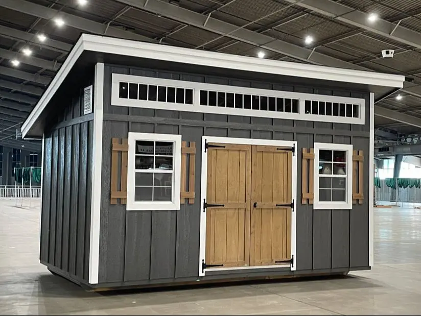 A shed with two windows and a door.