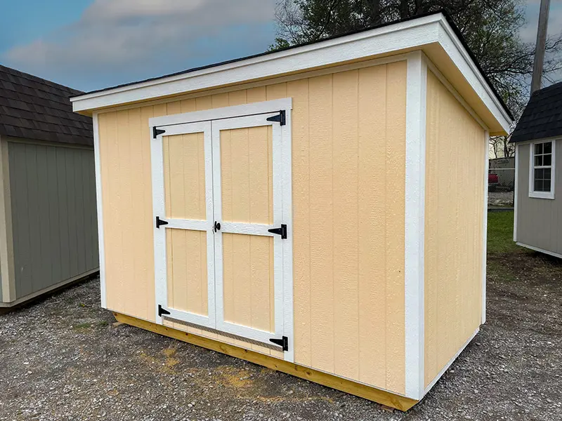 A small shed with two doors and a white trim.