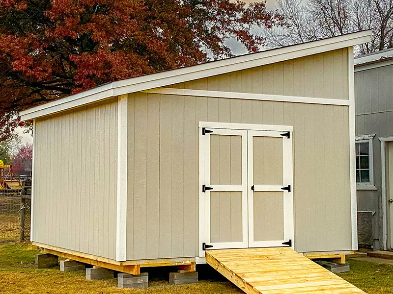A shed with a ramp leading to the door.