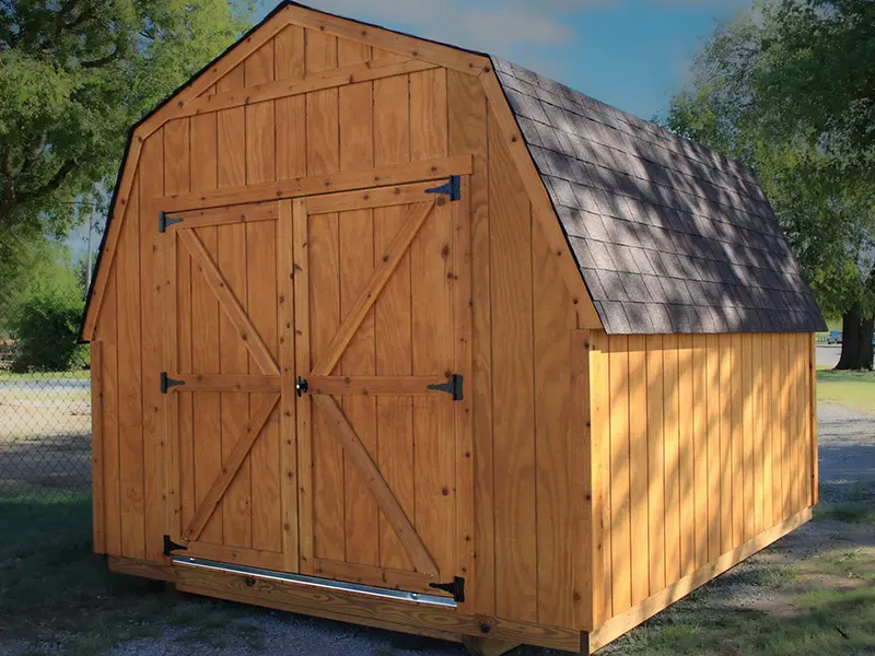 A wooden shed with two doors and no windows.