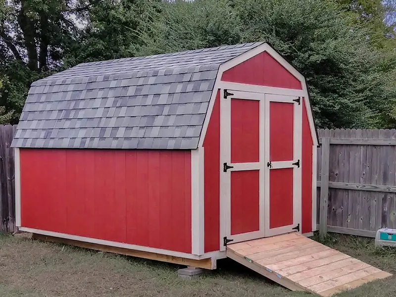 A red shed with a ramp in the front.