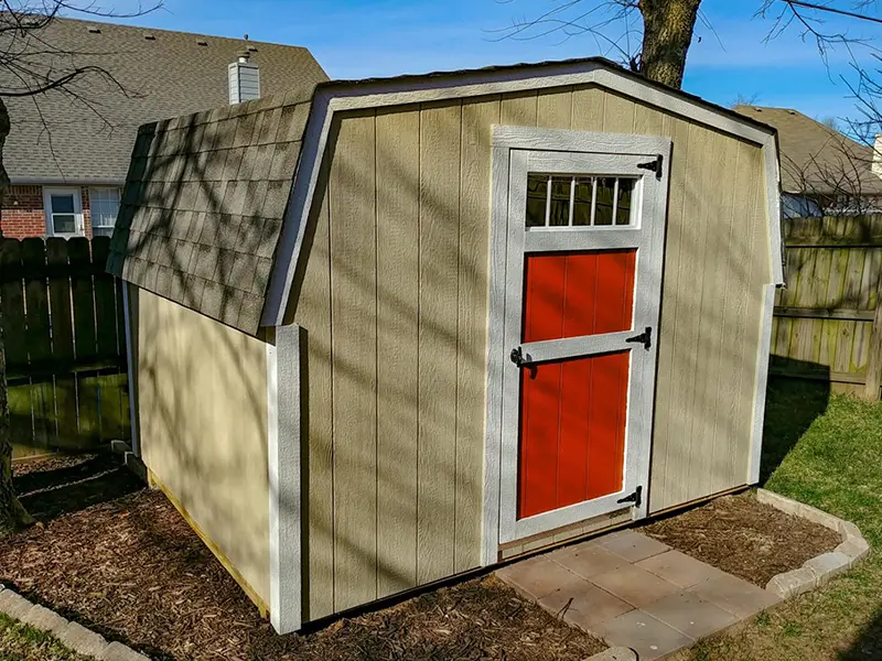 A shed with red door and white trim.