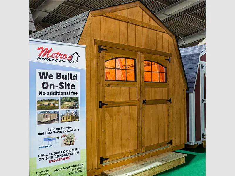 A wooden shed with windows and doors on display.