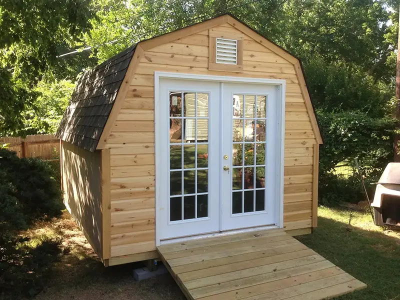A small shed with two doors and a ramp.