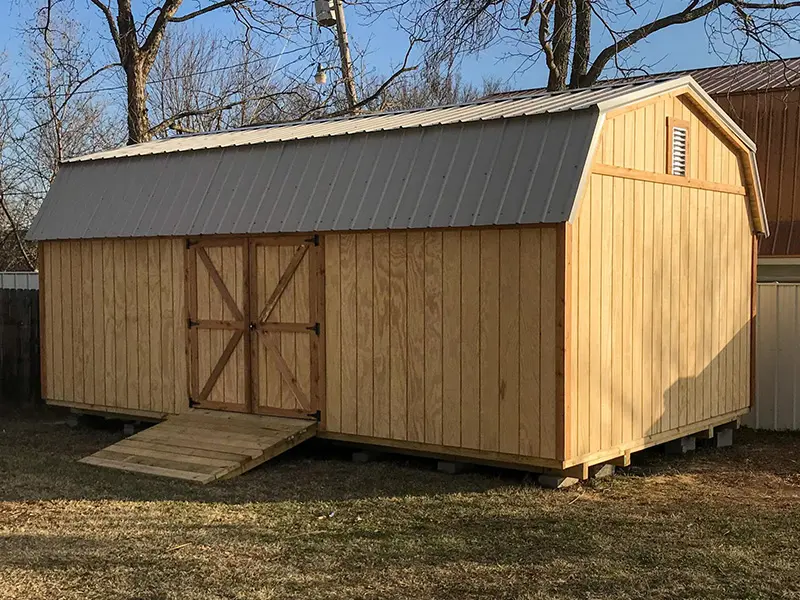 A shed with a ramp going up the side.