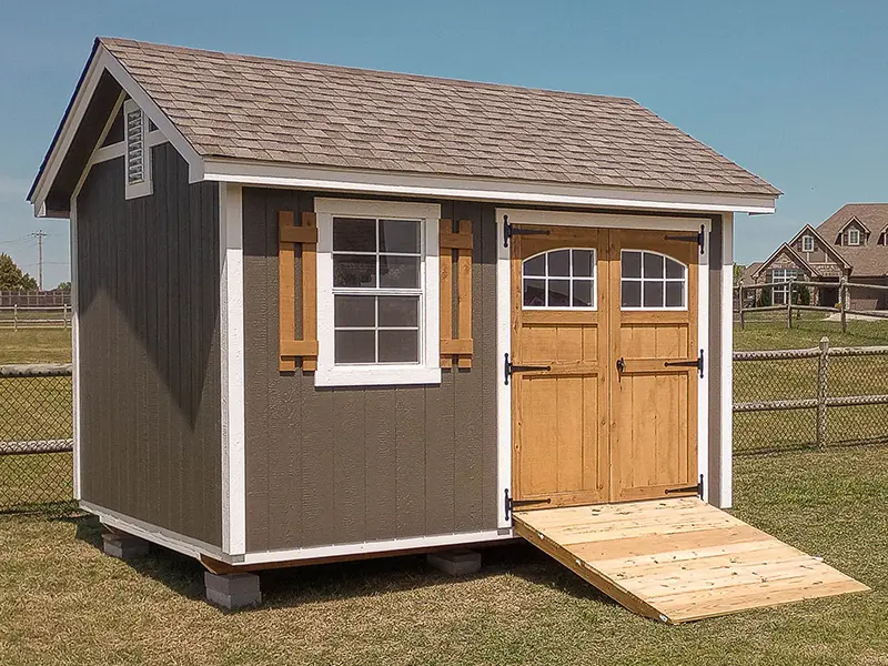 A shed with two doors and a ramp on the side.