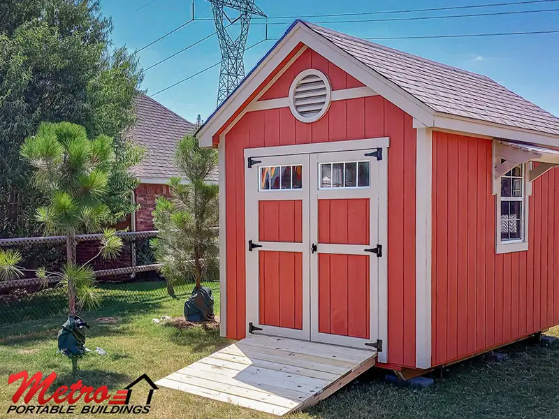 A red shed with a ramp leading to the side.